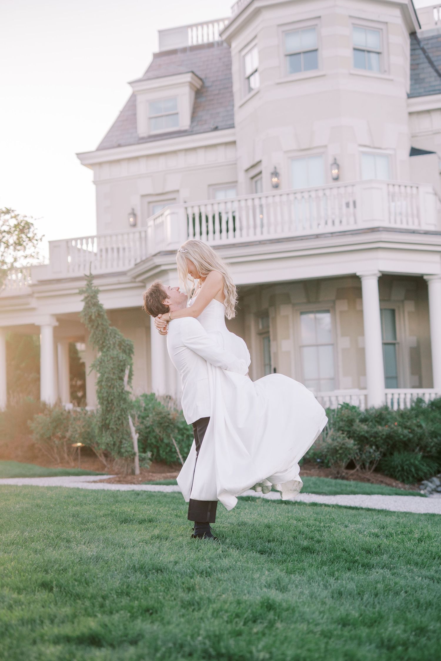 Classic white mansion with grand architecture and manicured lawn shown in a sequence of elegant lifestyle shots at sunset.