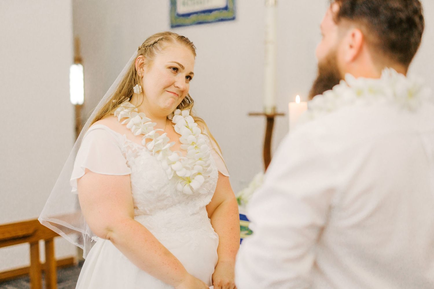A tender moment between a couple during their indoor wedding ceremony.