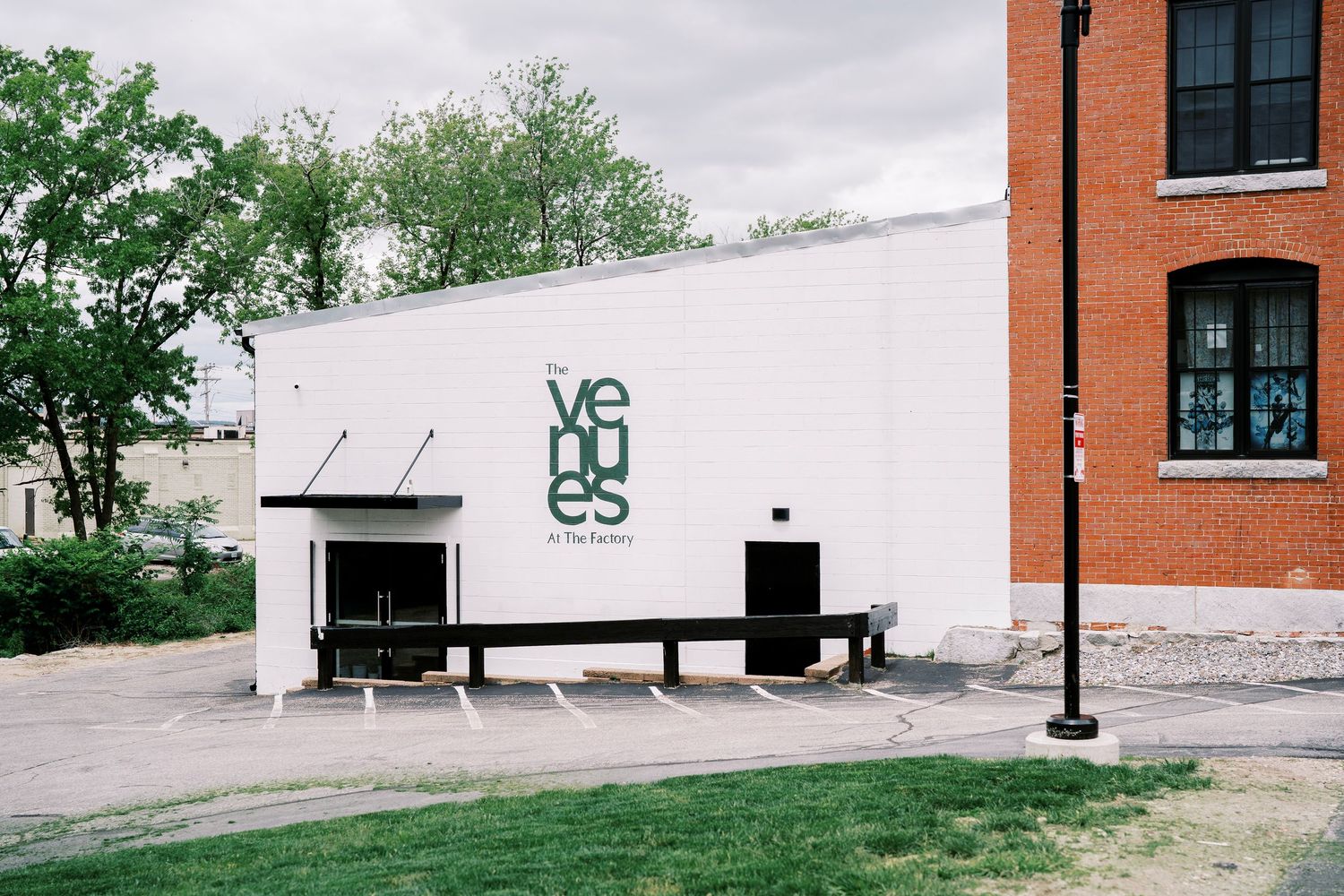 Modern white building exterior with 'VGES' signage and industrial aesthetic.