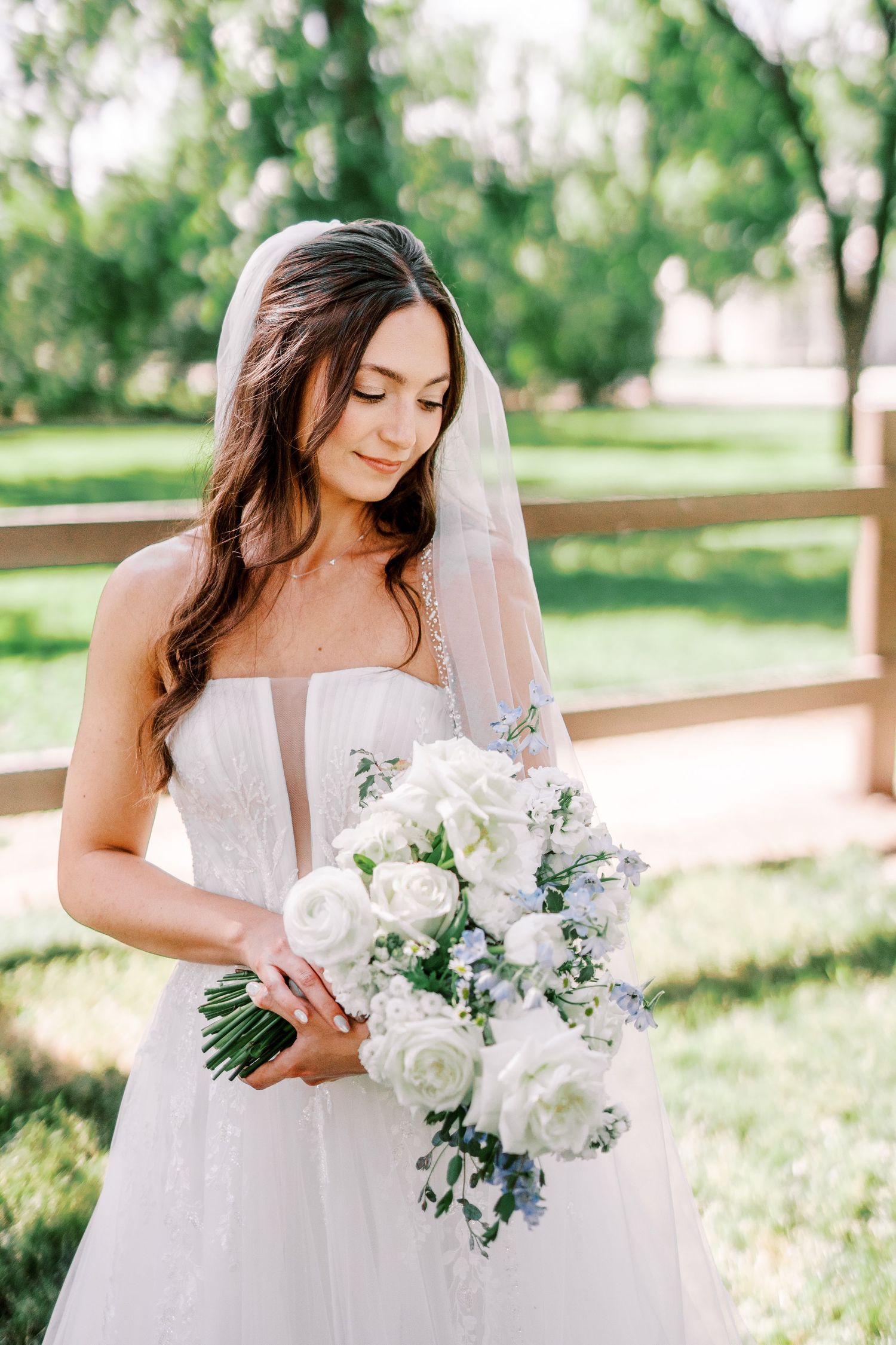 An elegant bridal portrait series showcasing a white bouquet and lace wedding dress in a sunlit outdoor setting.