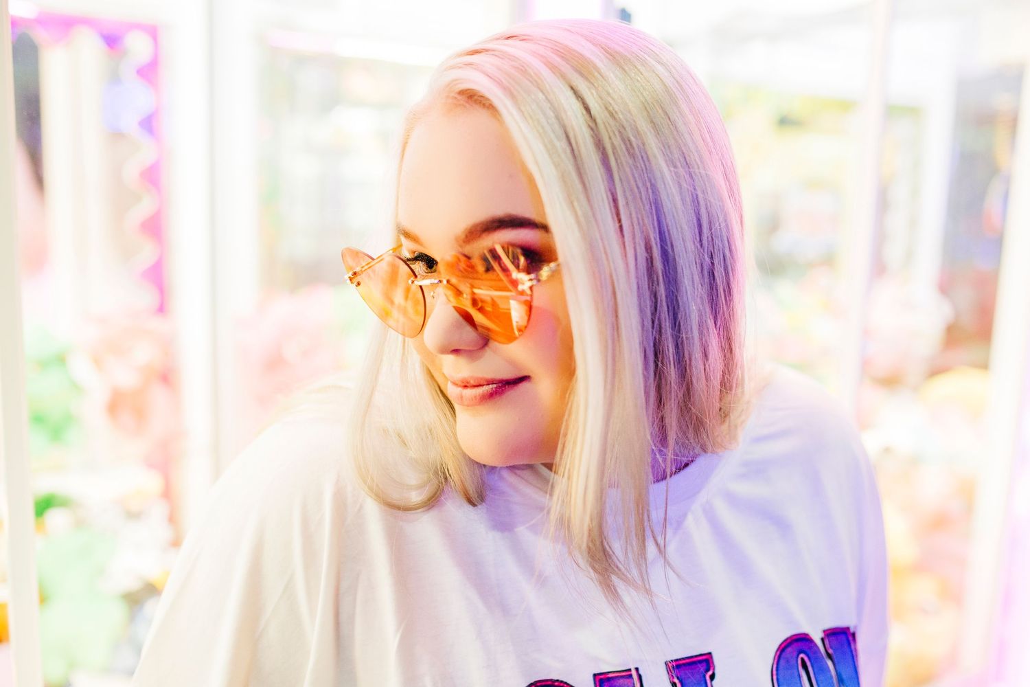Senior hanging out at the arcades with colorful glasses at Incredible Pizza in Springfield MO.