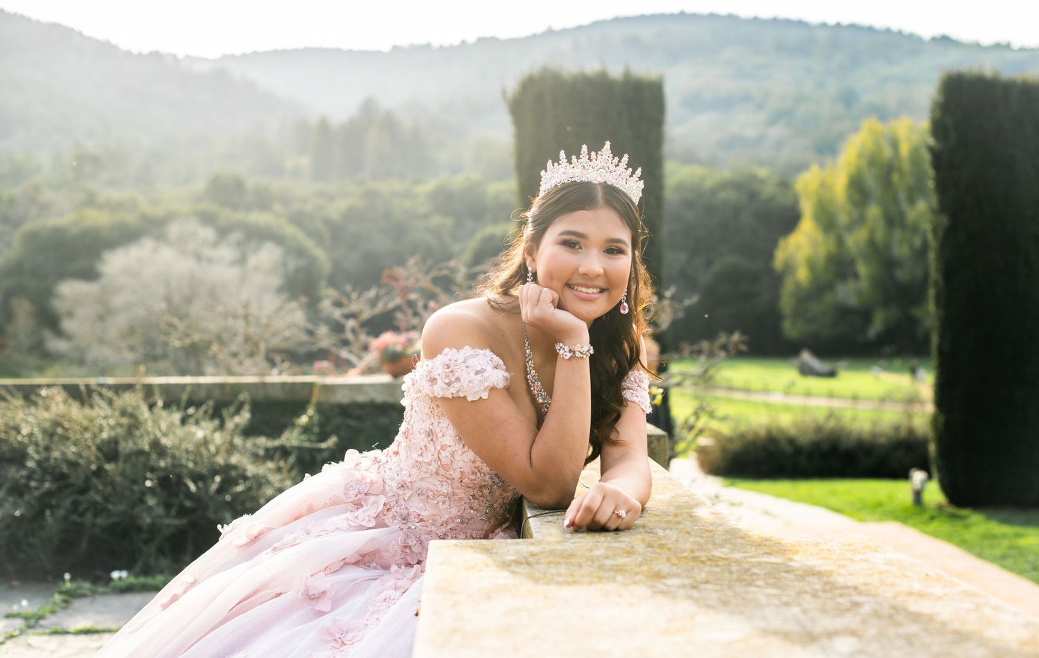 A scenic outdoor portrait session in a pink gown features romantic poses and natural lighting across multiple settings.