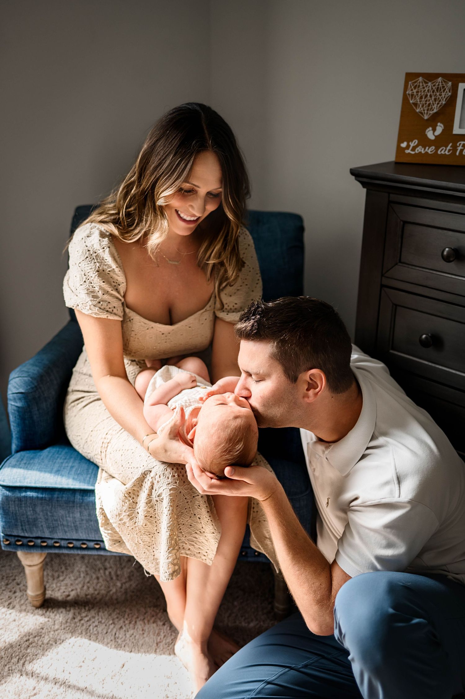 Parents share a gentle moment with their newborn baby with best newborn photographer chapel hill nc