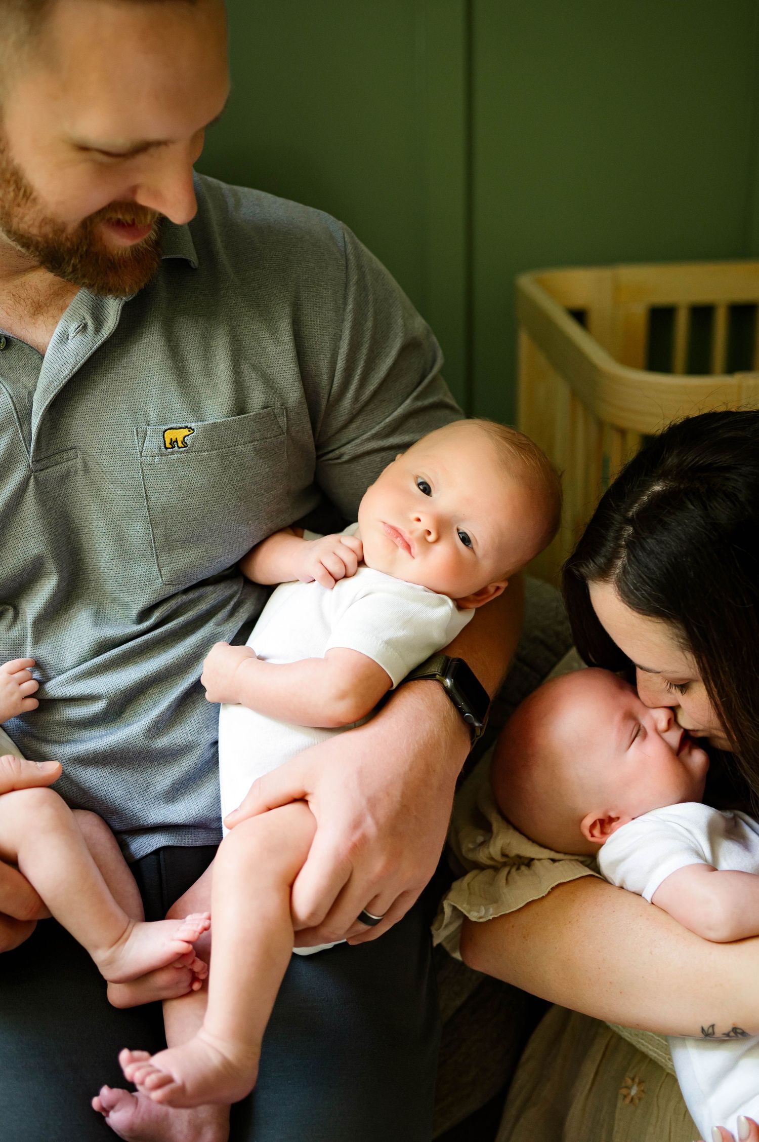 A tender family moment showing a parent cuddling with their newborn son during photoshoot with durham newborn photographer