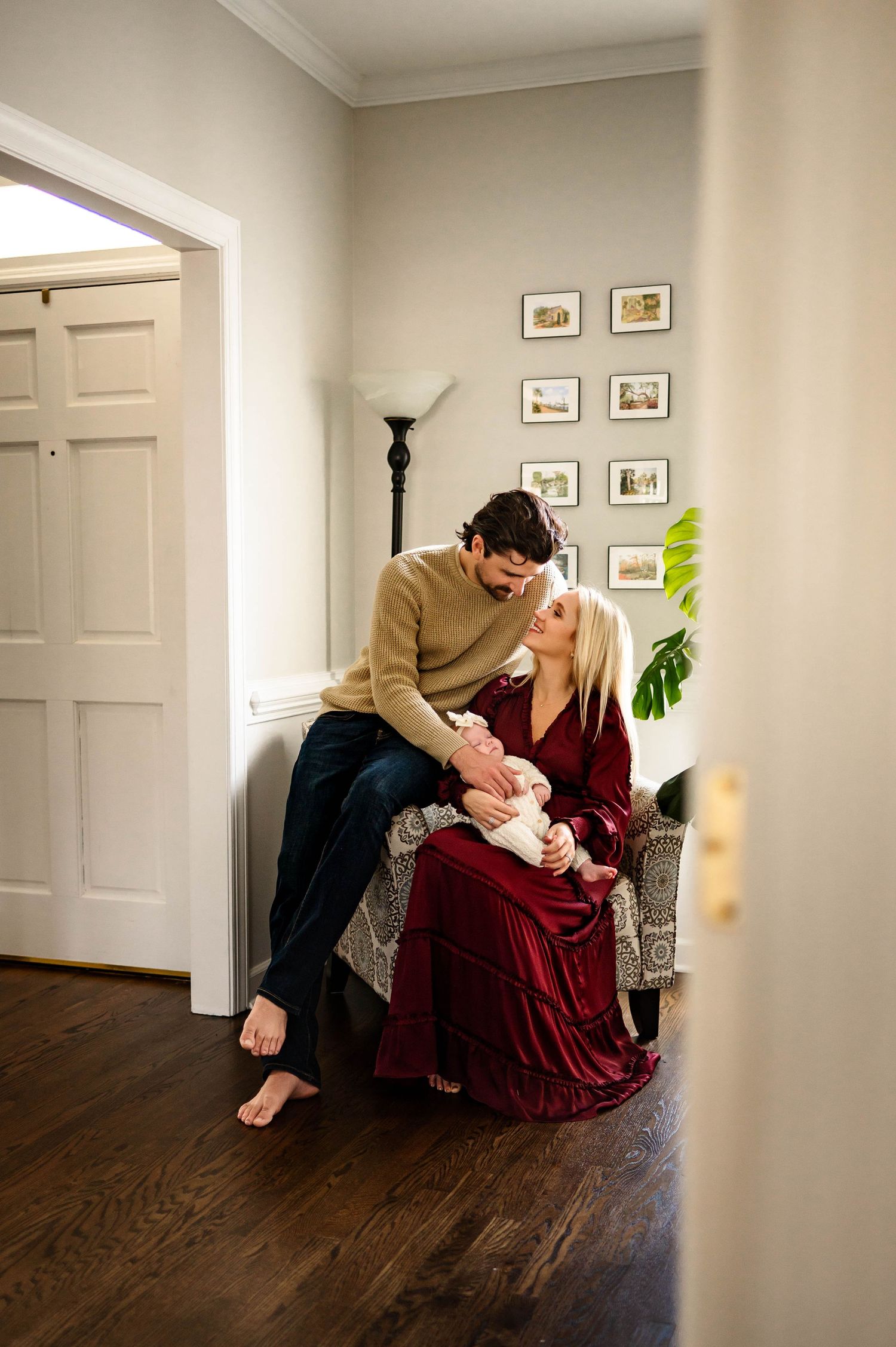 Couple in casual clothes shares an intimate moment in a cozy living room intimate photo session with raleigh newborn photographer