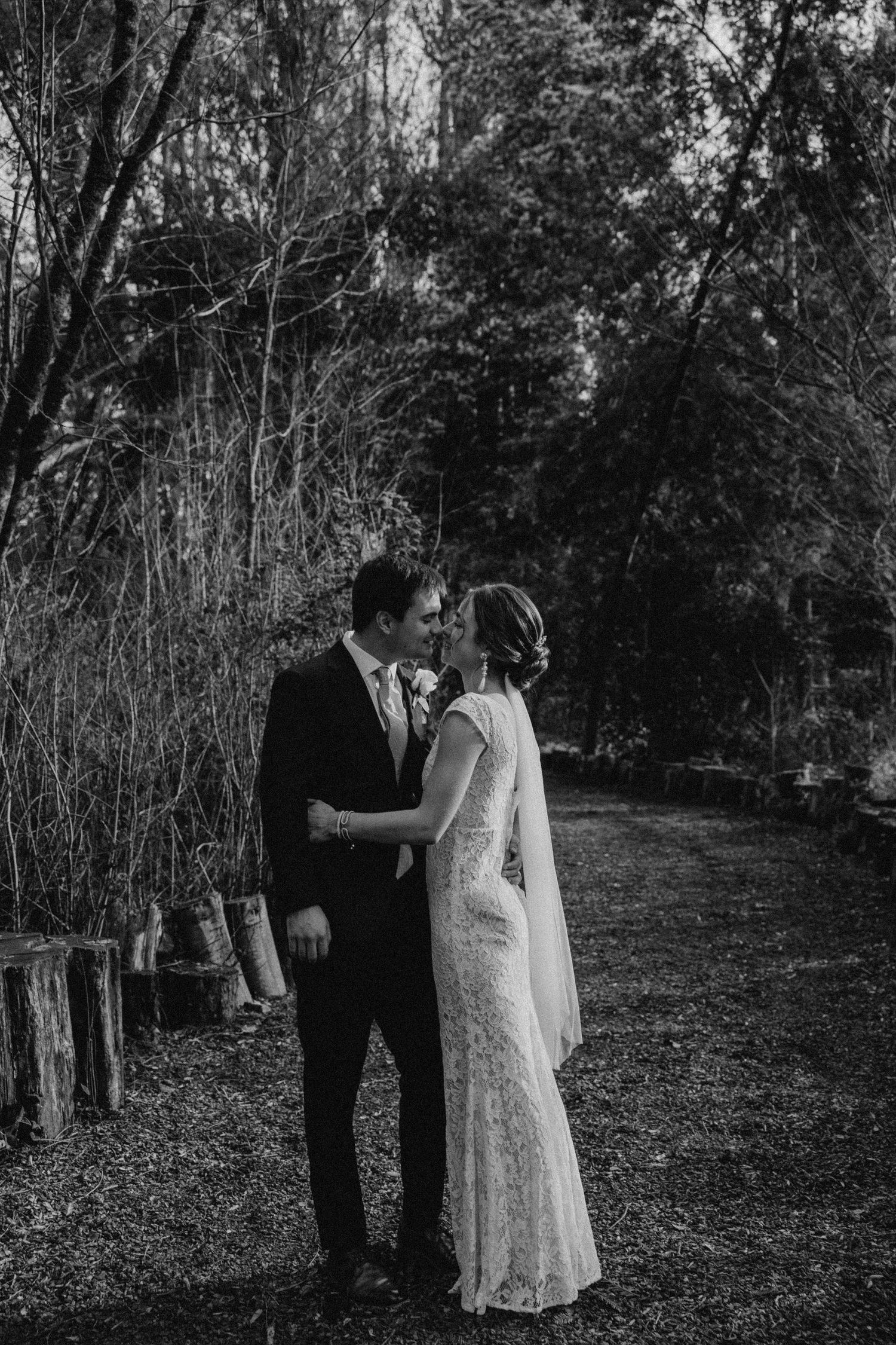 couple at their elopement in the redwood forest holding each other closely