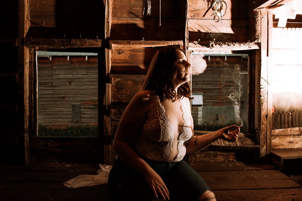 Lifestyle portrait in rustic setting with warm lighting and wooden textures.