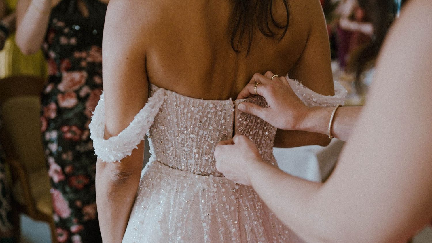 Close-up details of romantic lace wedding dress with delicate beading and floral embellishments.