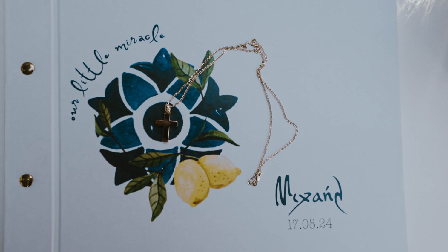 Handmade greeting card featuring a blue and green paper flower with yellow accents and a delicate chain decoration.