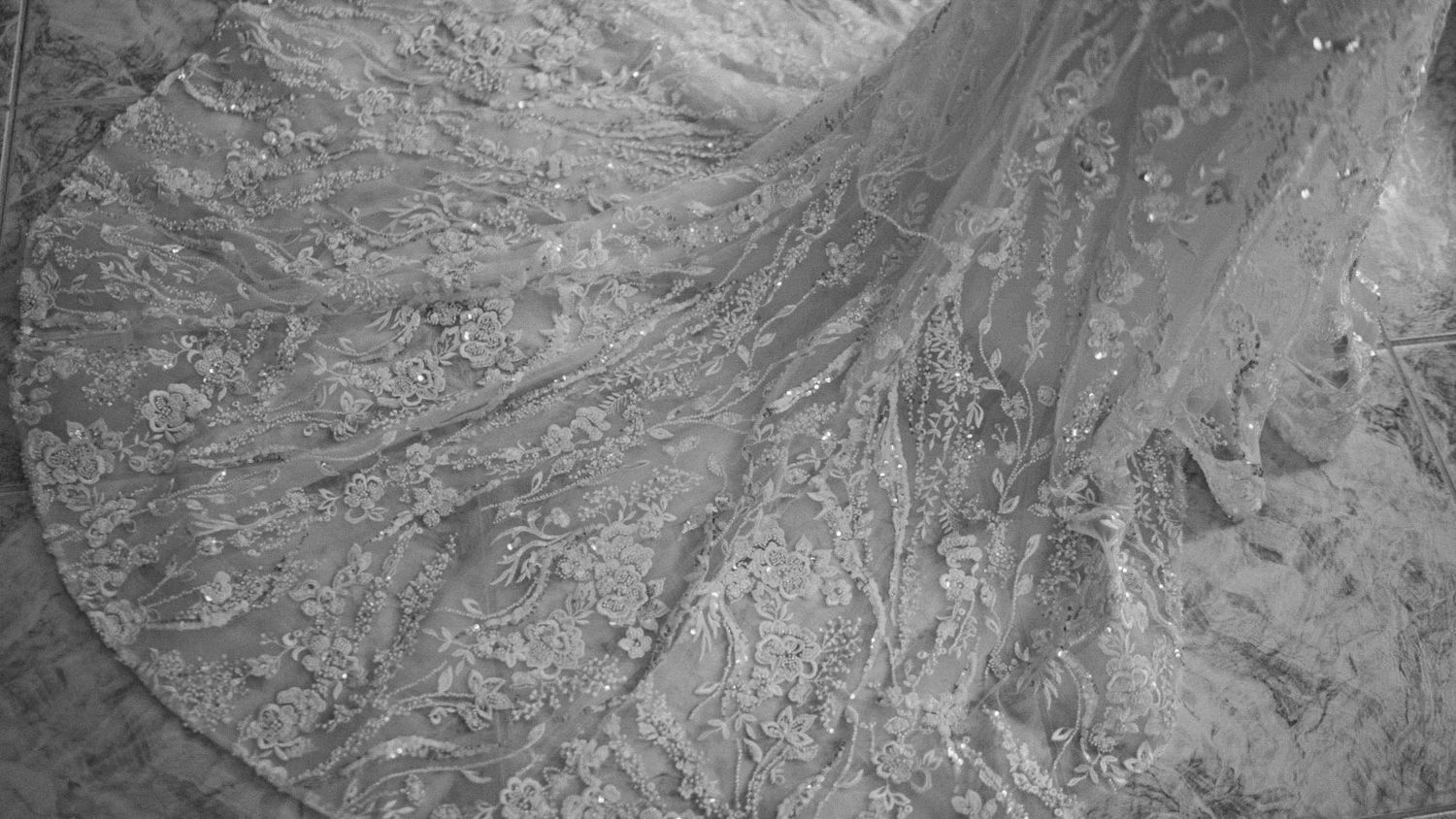Black and white aerial photograph showing rugged mountain terrain with steep slopes and geological formations.