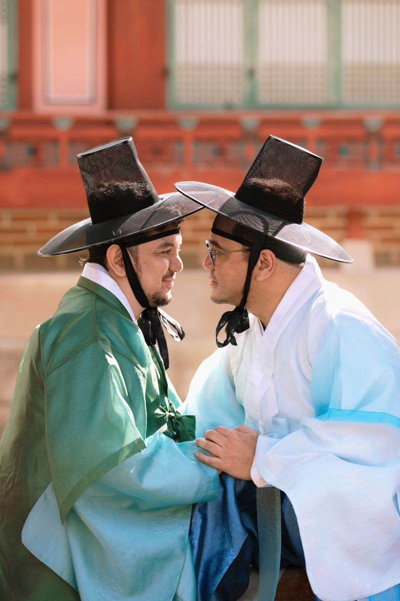 Traditional Korean drama scene showing two men in historical costumes having an intense confrontation.