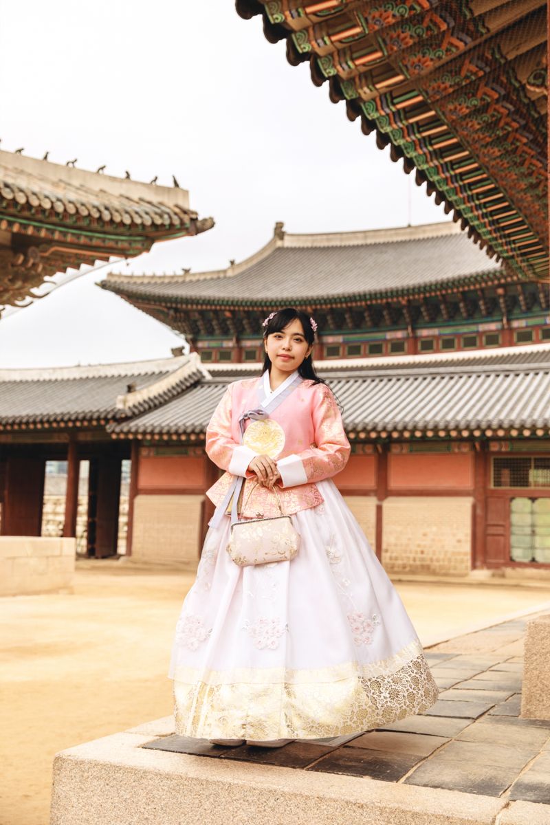 Traditional Korean palace architecture with ornate rooftops and colorful decorative elements at Gyeongbokgung Palace in Seoul.