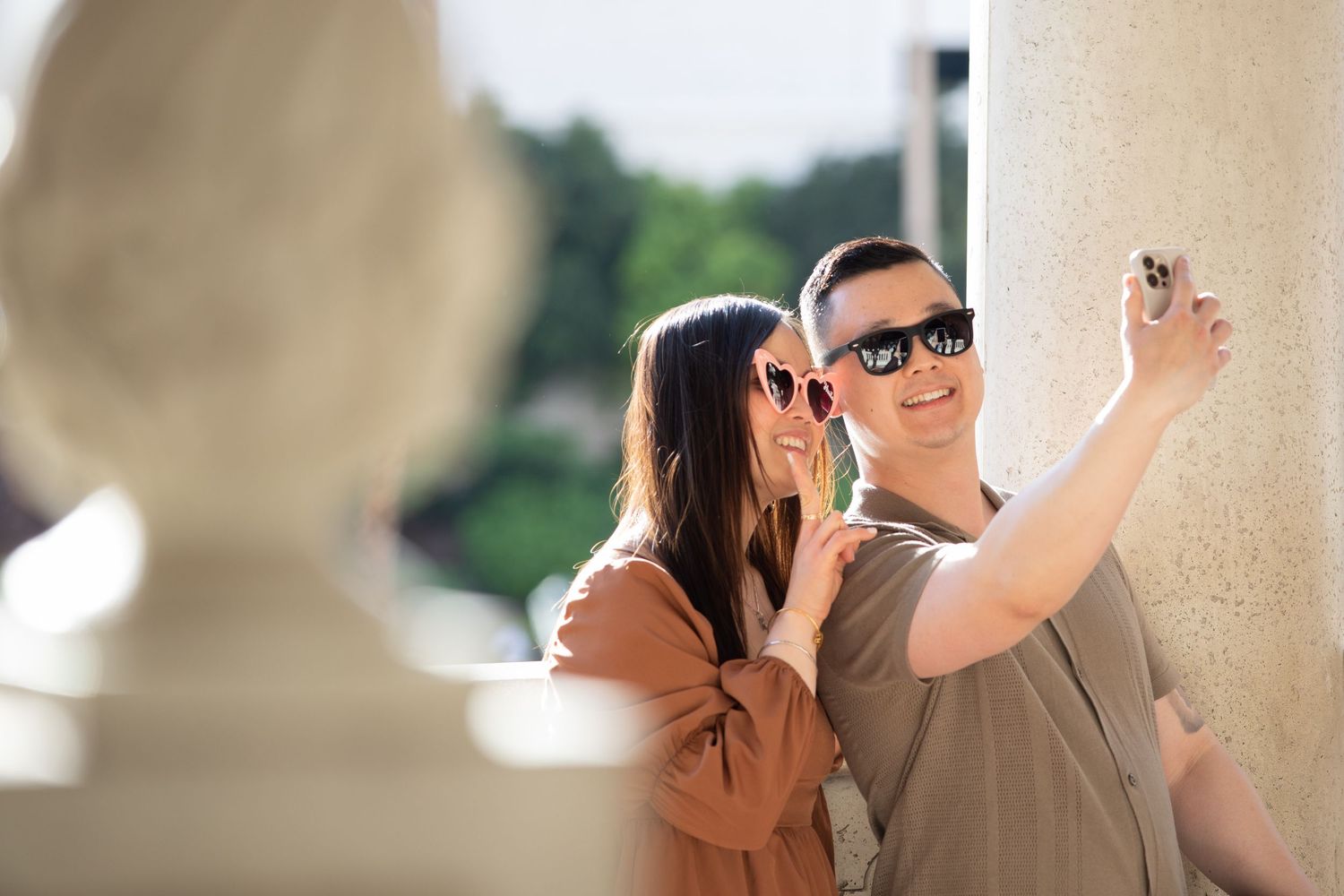 Sweet moment between couple under urban architecture with soft lighting.