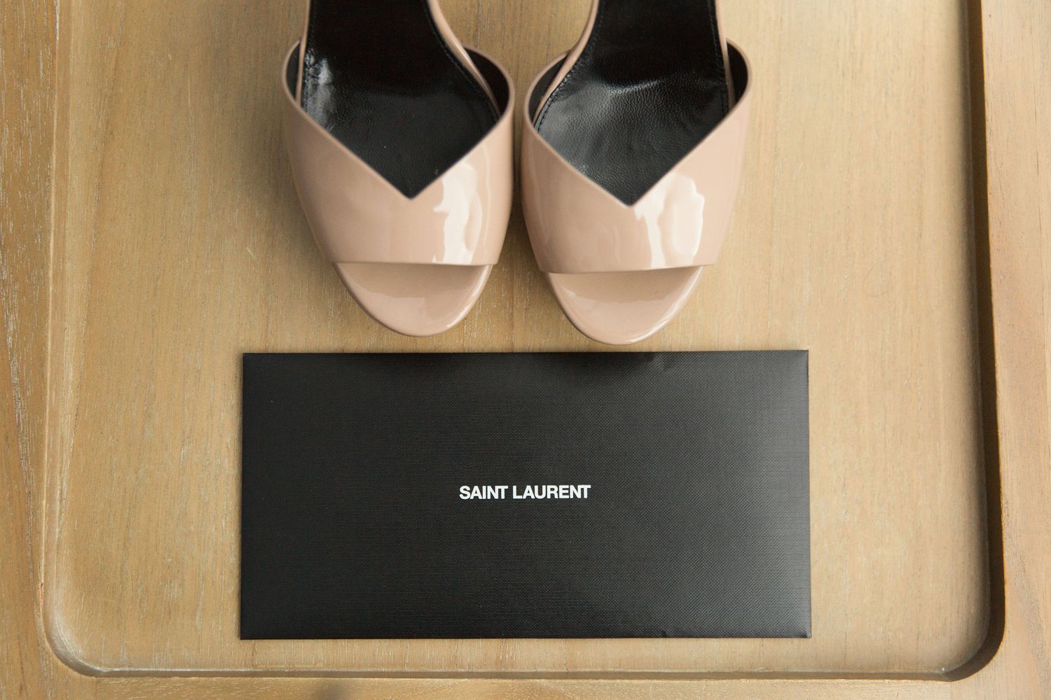 Designer bridal shoes arranged with packaging and accessories.