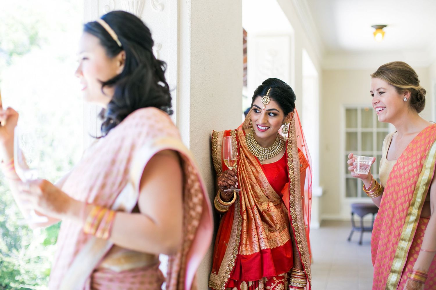 Wedding party members in traditional Indian attire preparing for celebrations.