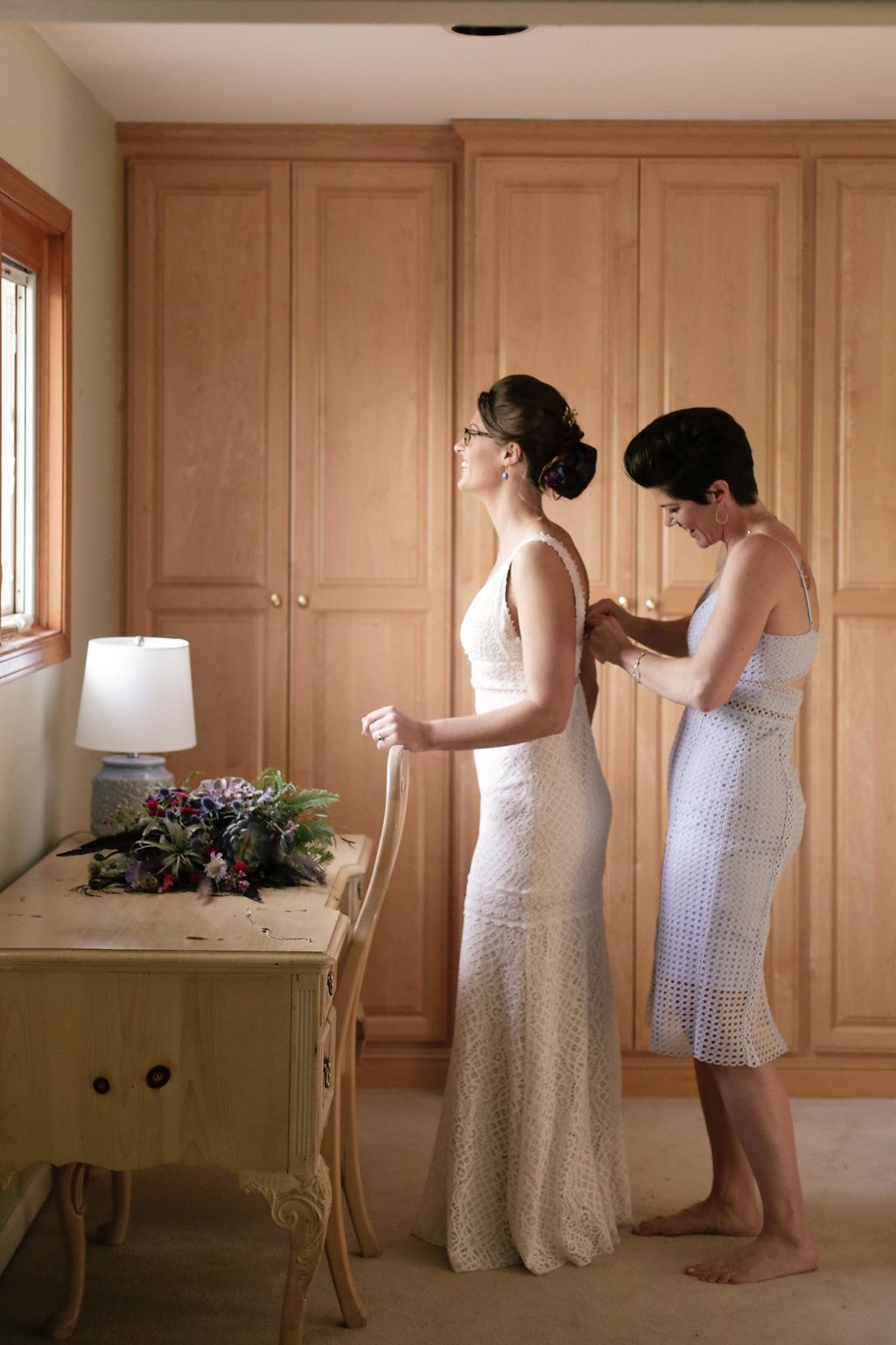 Getting ready sequence showing wedding preparations in a room with wooden cabinets.