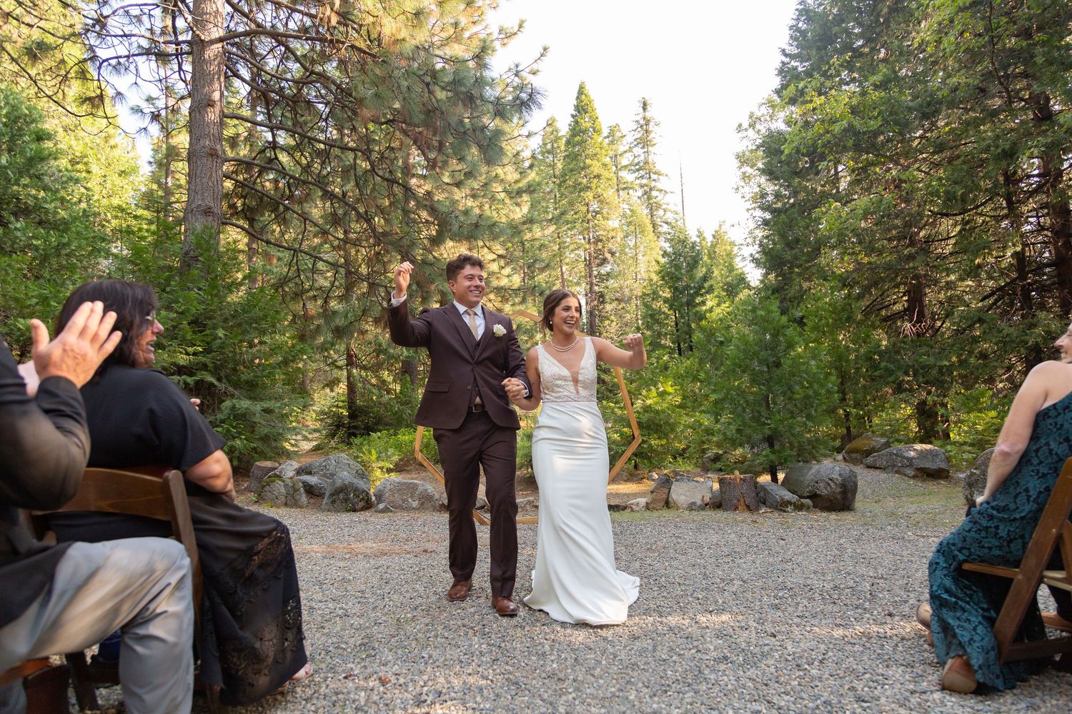 Wedding celebration candid moments captured in an outdoor forest setting.