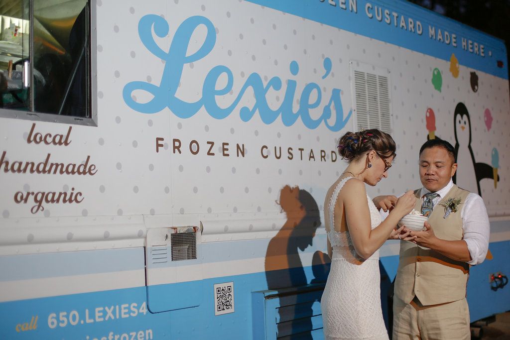People lined up outside a blue ice cream shop called Lexie's serving frozen custard.