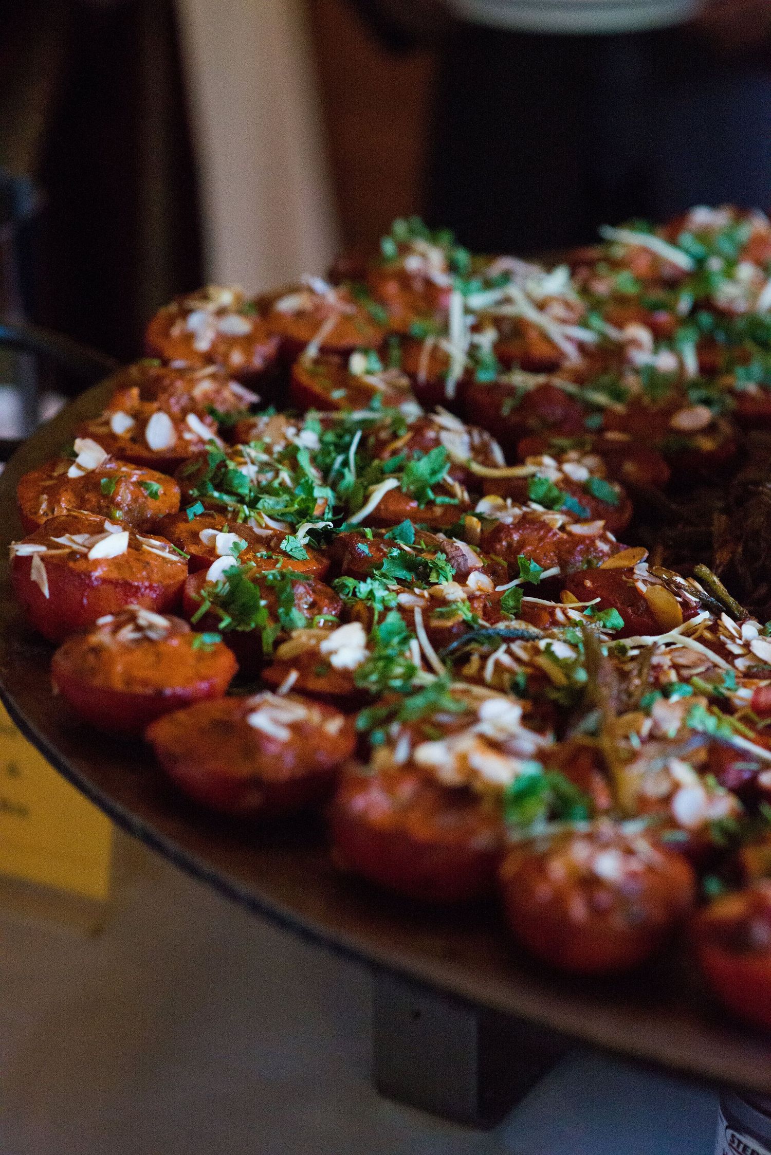 Platter of garnished appetizers topped with fresh herbs and microgreens served at a reception.