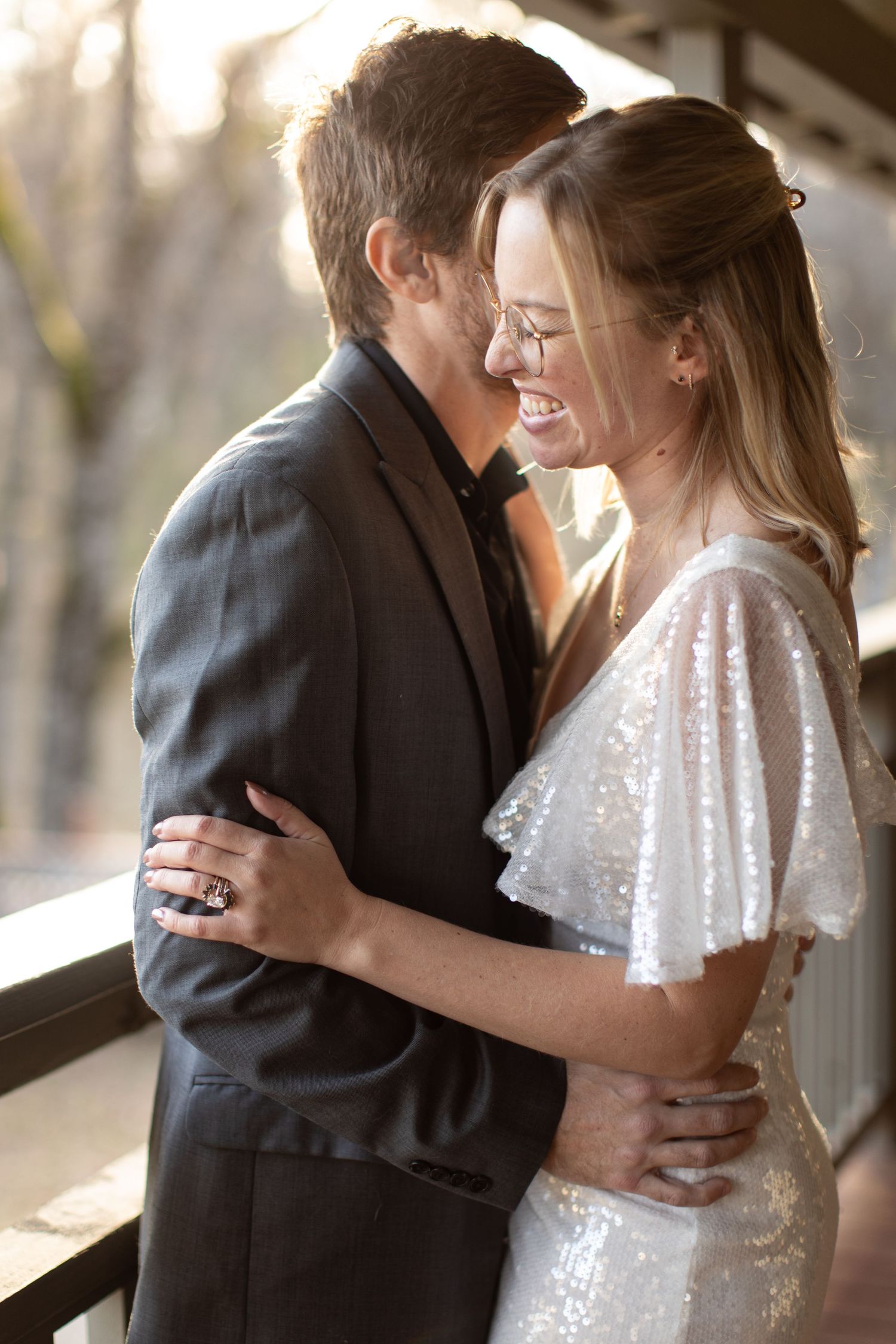 A tender moment captured between a couple in formal attire with soft lighting.