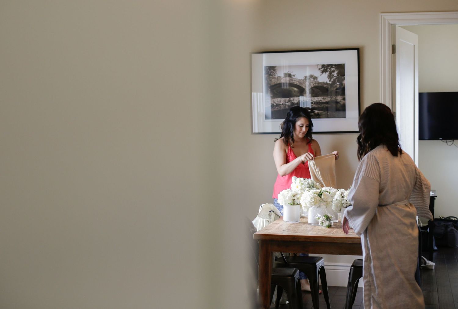 A quiet indoor space with people preparing before a special event.
