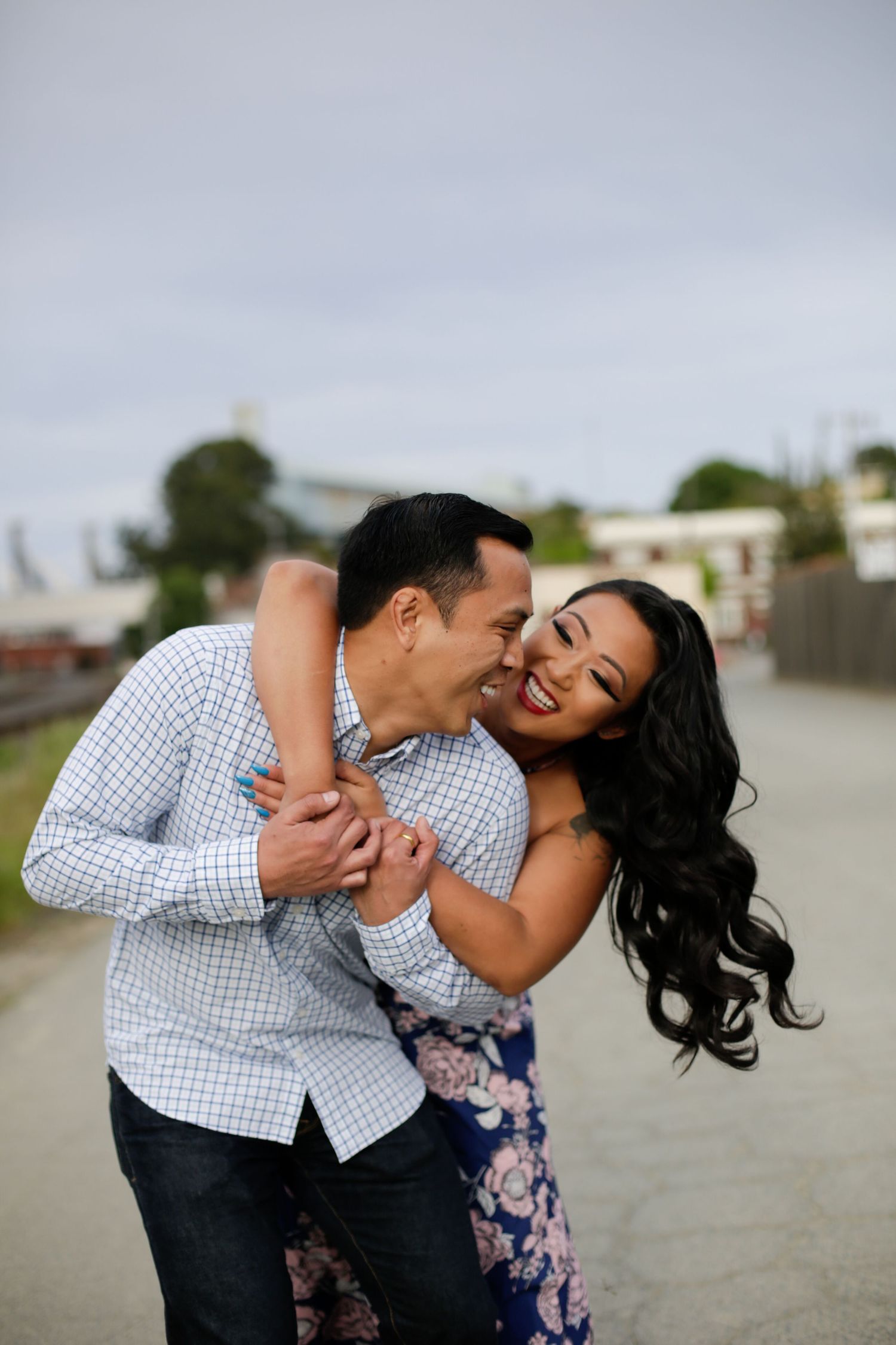 A couple sharing a joyful moment together on a rooftop.
