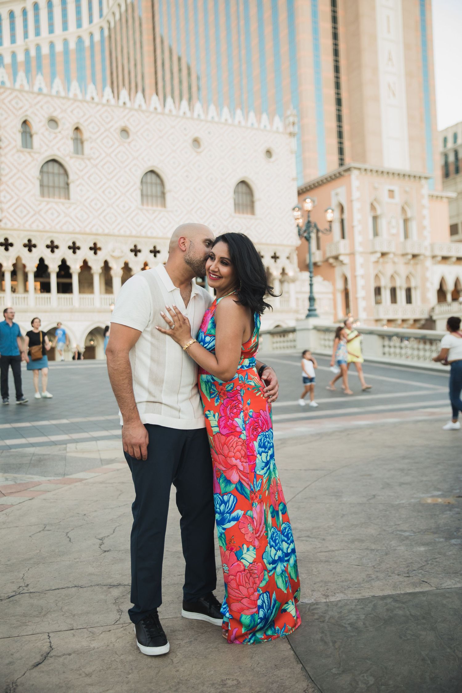 A couple poses affectionately outside the Venetian Hotel in Las Vegas.