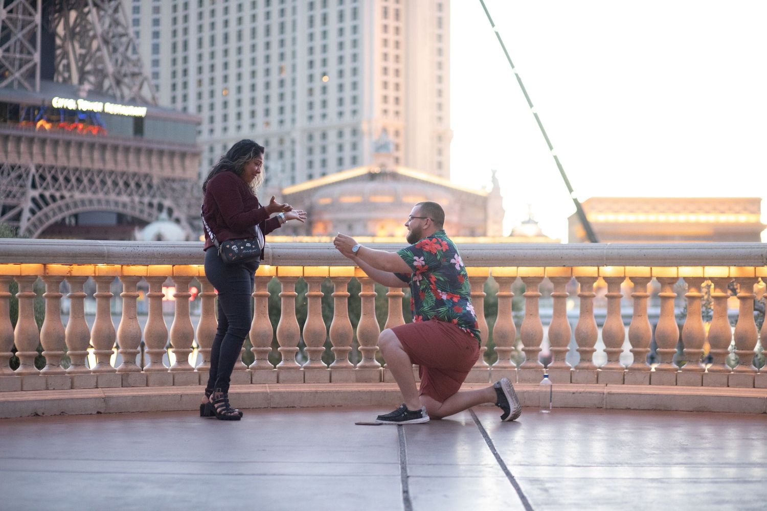 A surprise proposal moment captured at a Las Vegas hotel balcony with city views.