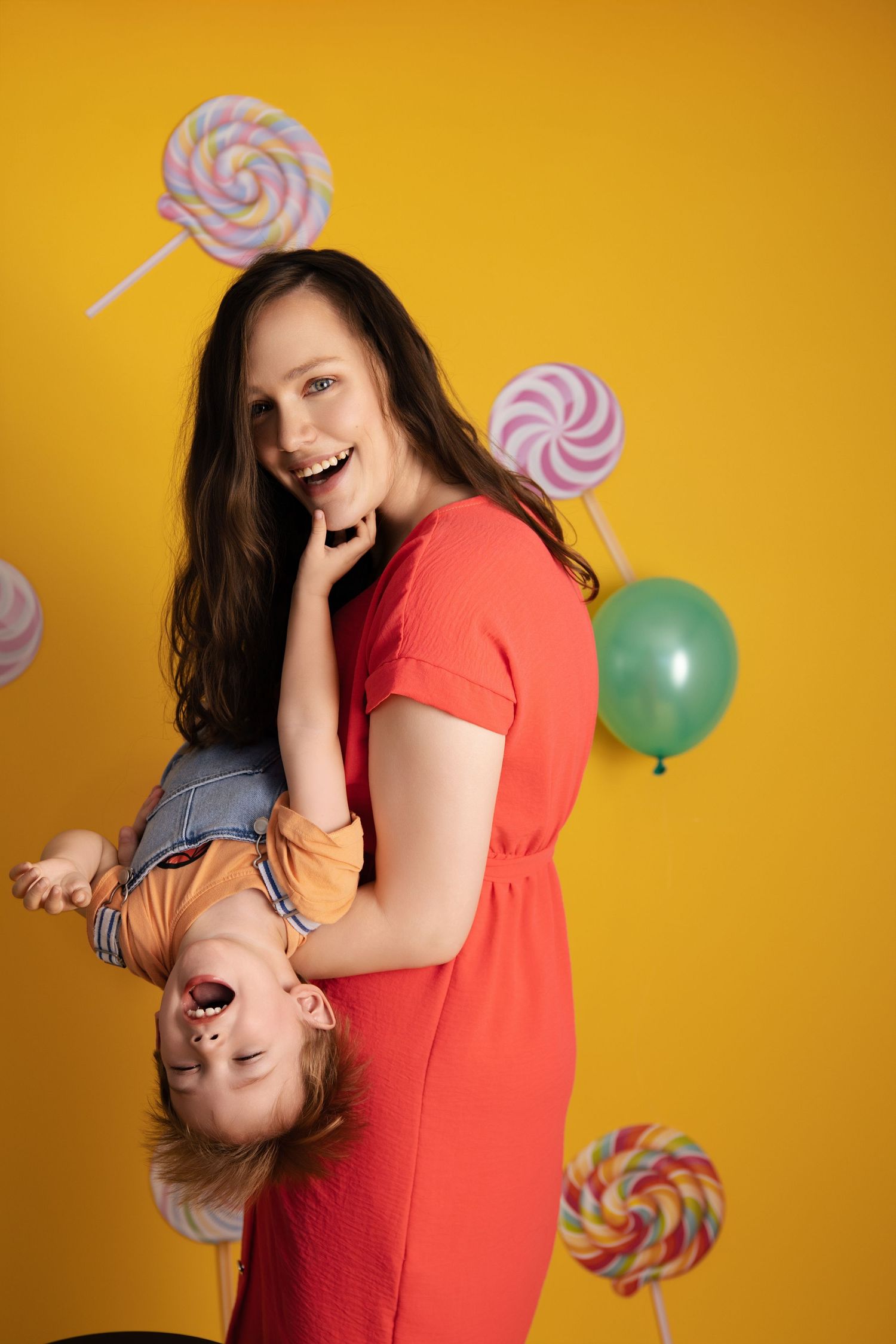 A playful series of poses with balloons and lollipop props against a vibrant yellow backdrop.
