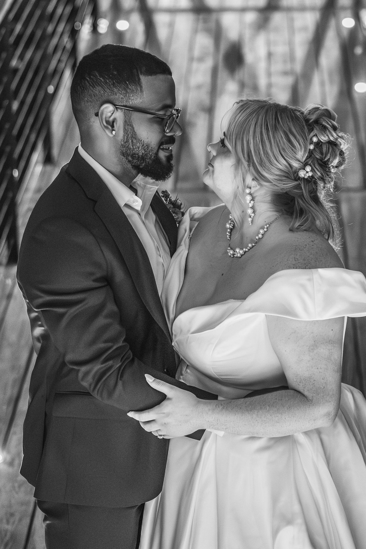 Intimate black and white portrait of newlyweds sharing romantic moment.
