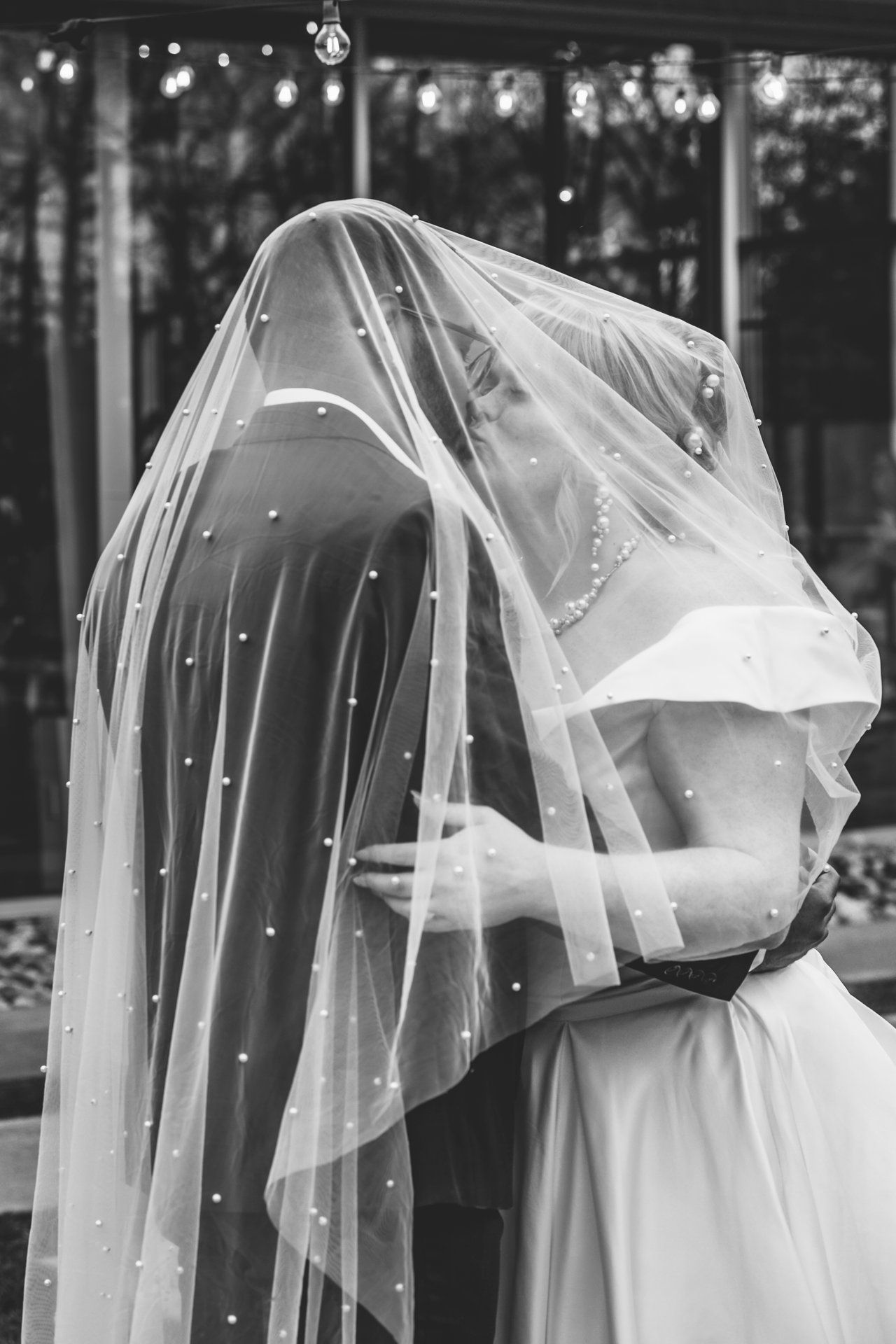 Elegant bridal veil with pearls captured in dramatic black and white.