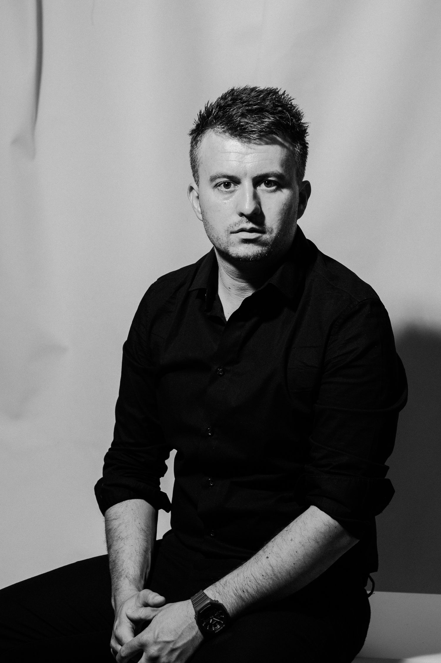 Dramatic black and white studio portraits captured in moody side lighting against a dark background. Marin Filipčić