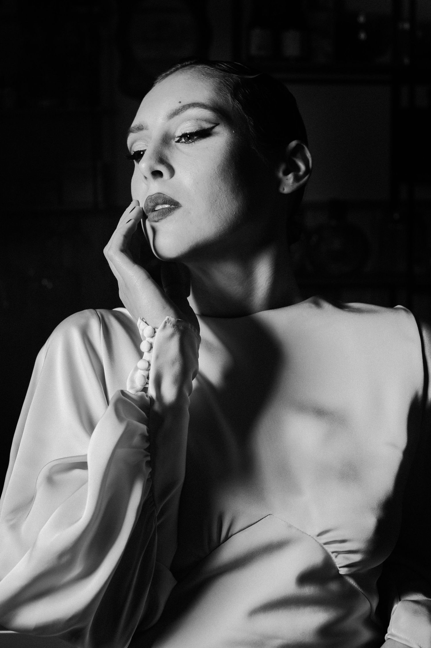 Dramatic black and white close-up portrait of Nika Barišić featuring sleek styling and expressive pose. Actor, famous