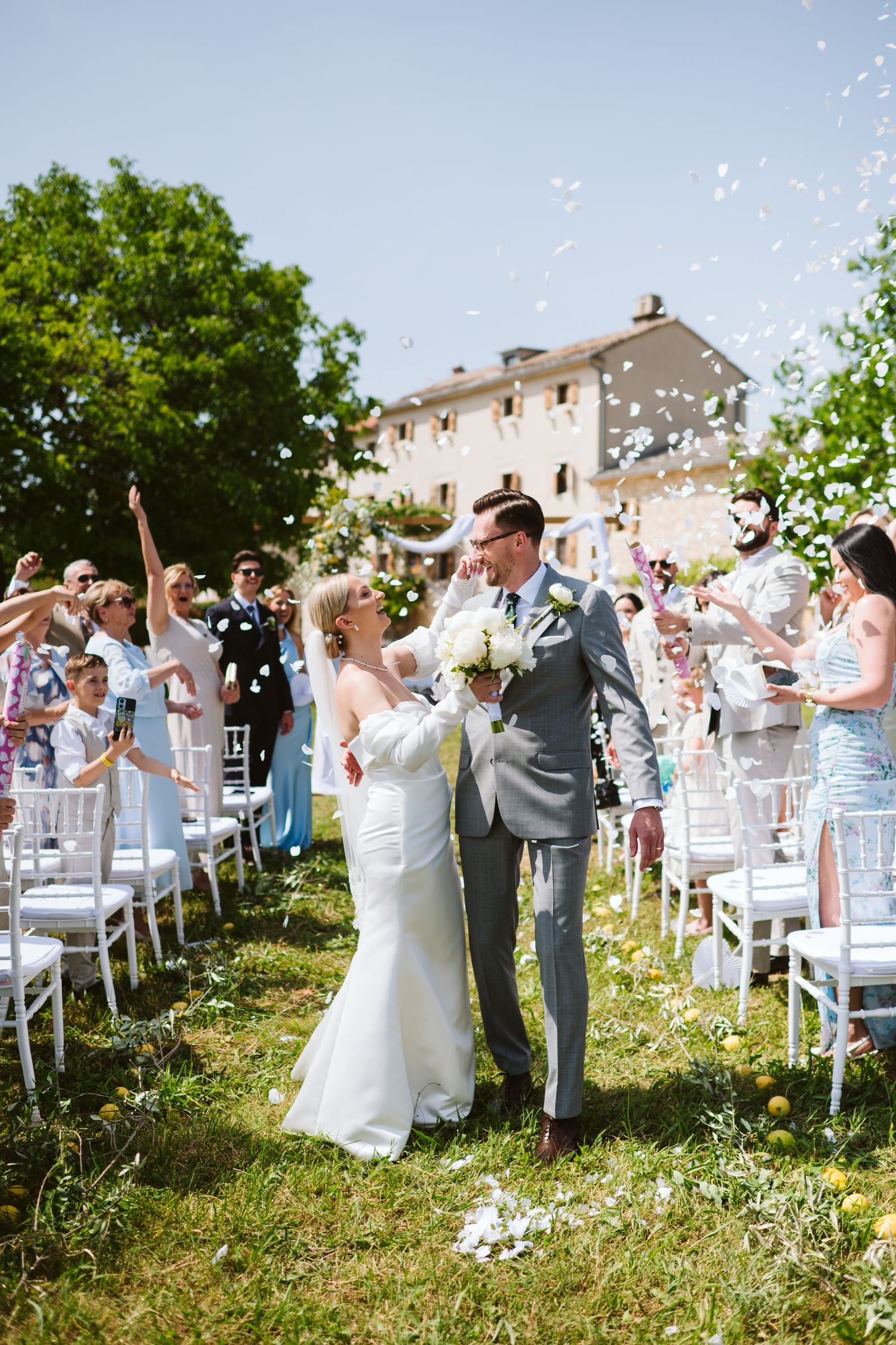 Emotional moment as newlyweds are embraced by loved ones in rustic Istrian setting