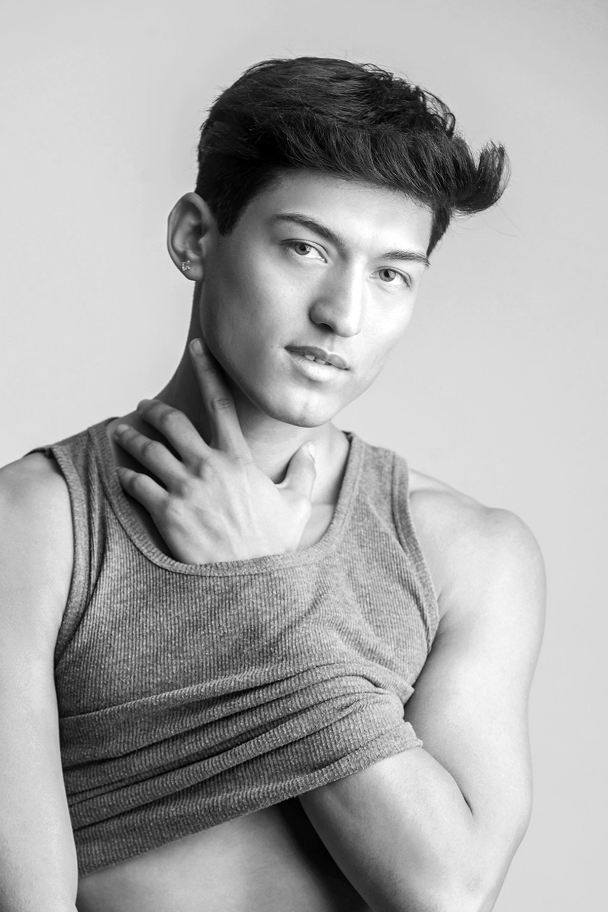 Black and white portrait showing artistic poses in a tank top.