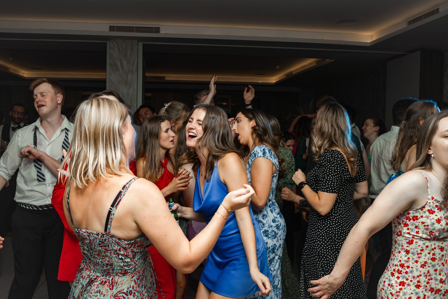 People dancing together at a lively indoor party or celebration event.
