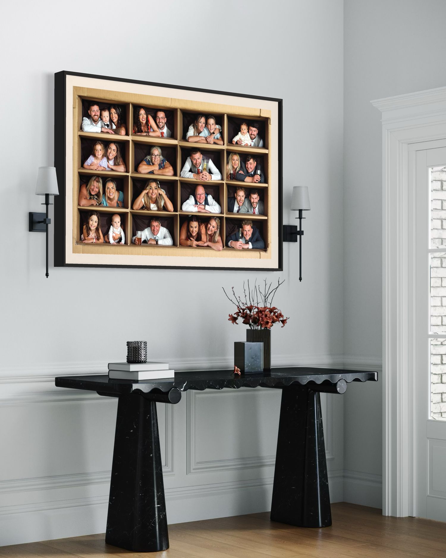 Modern interior with a large framed vintage photograph display above two black stone console tables and wall sconces.