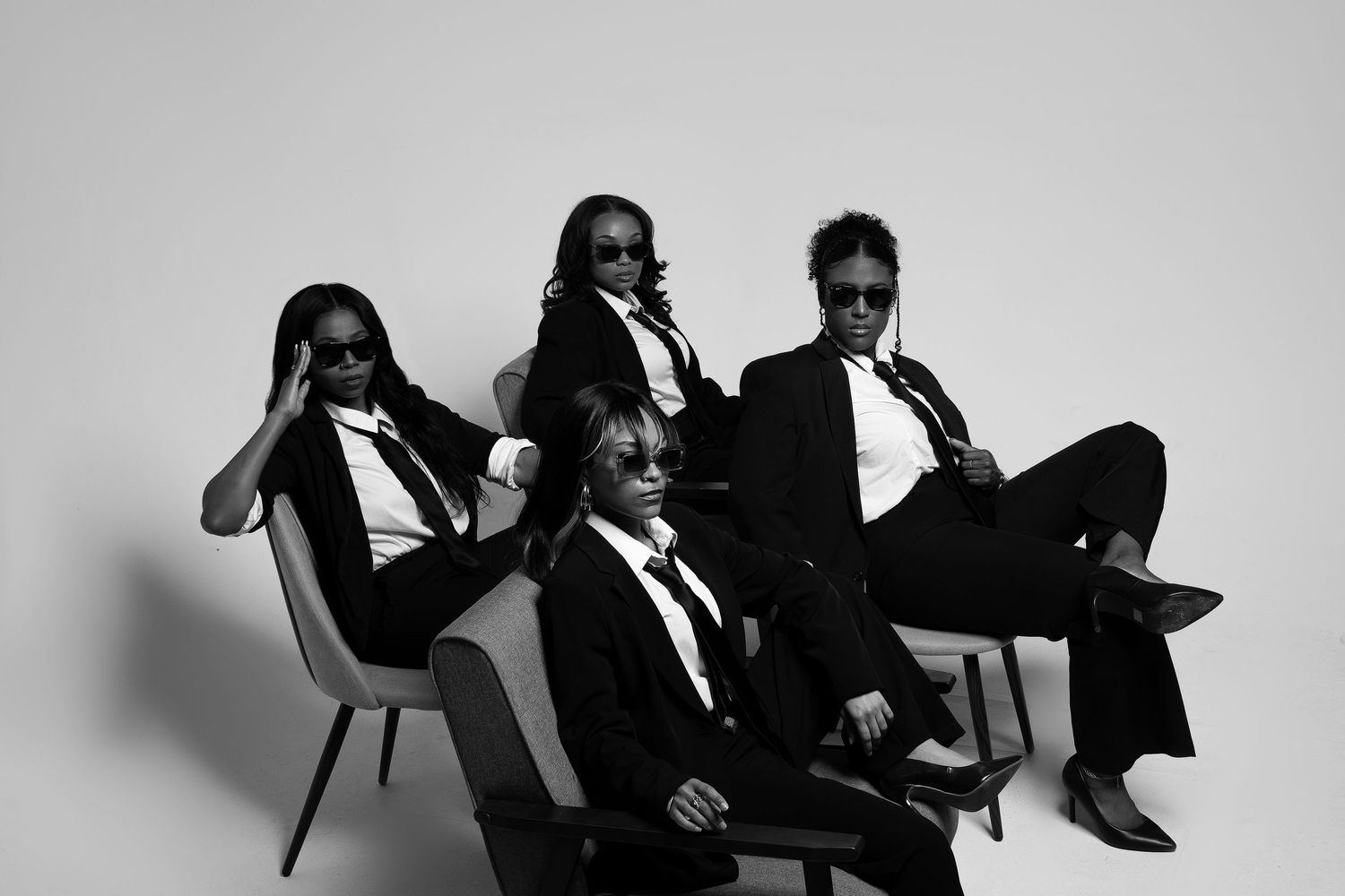 Black and white group portrait series showing artistic poses and styling.