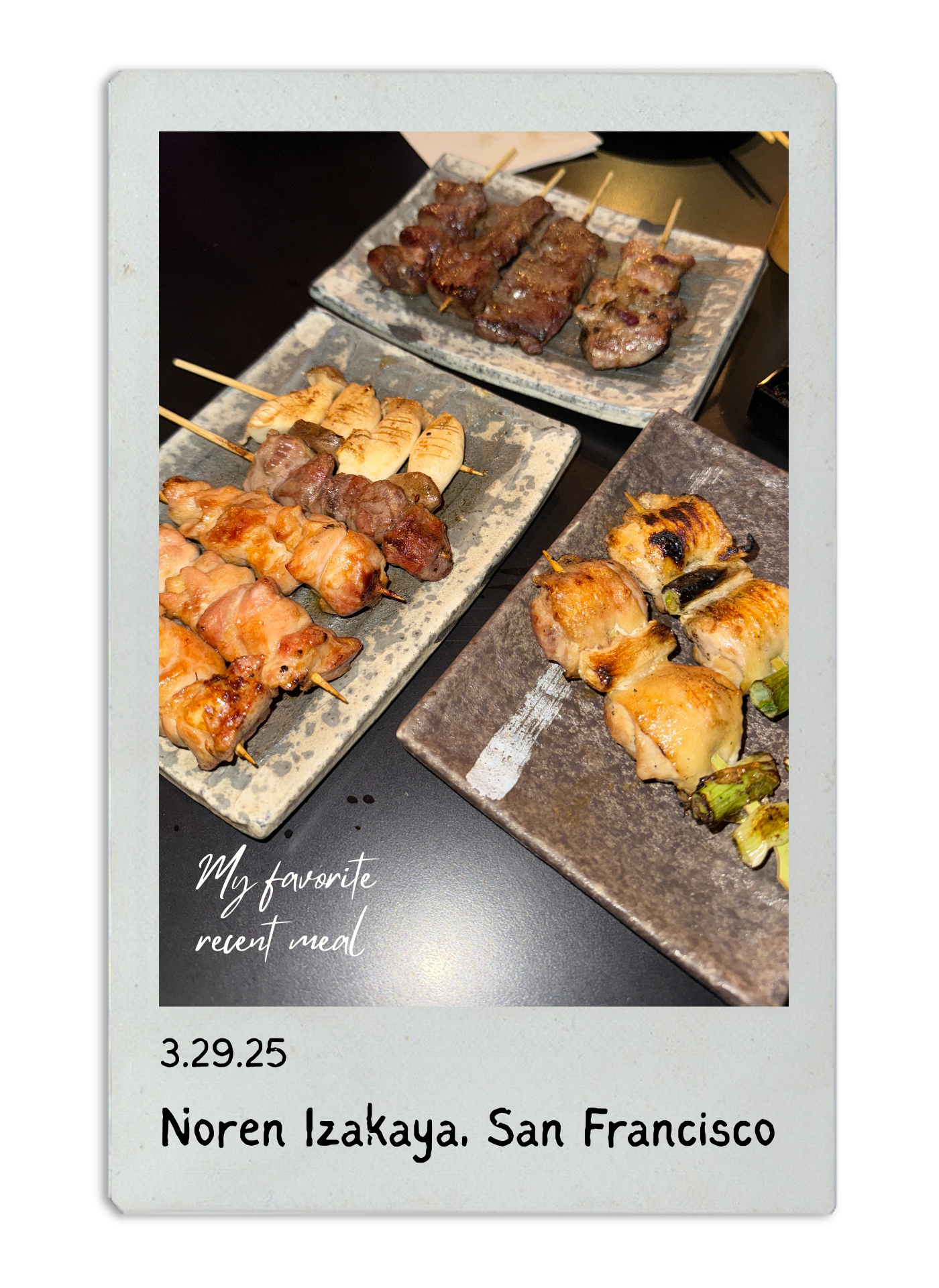 Various grilled yakitori skewers displayed on stone plates at a Japanese restaurant.