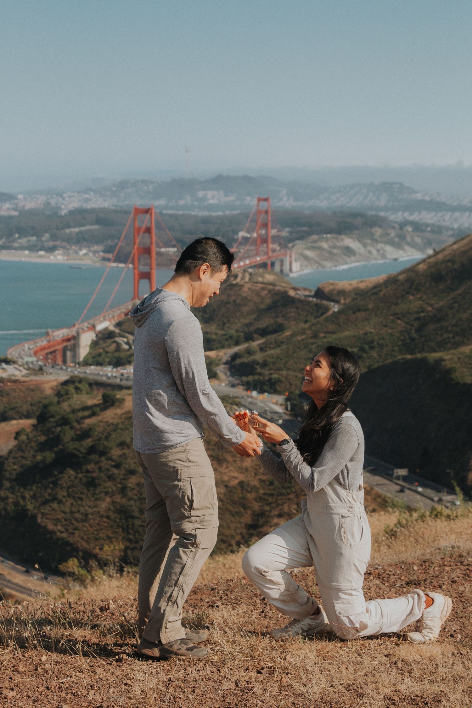 A romantic proposal sequence with the iconic Golden Gate Bridge in San Francisco visible in the background.