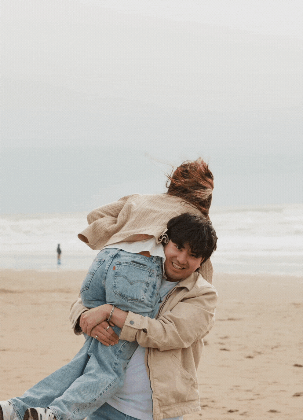 A GIF of a couple spinning joyfully in Ocean Beach, California.