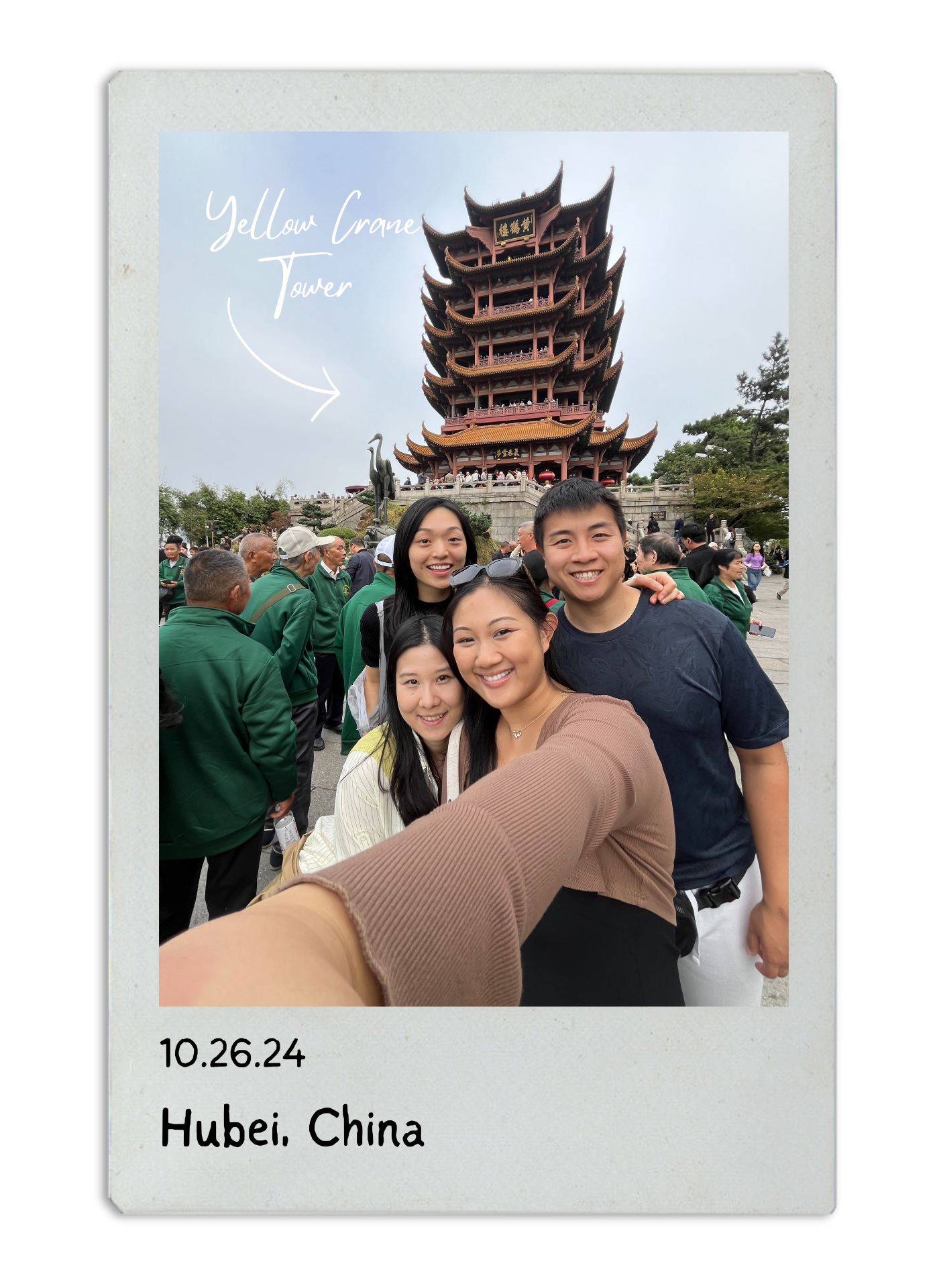 Traditional pagoda tower at Yellow Crane Tower scenic spot in Hubei China with tourists gathered around.