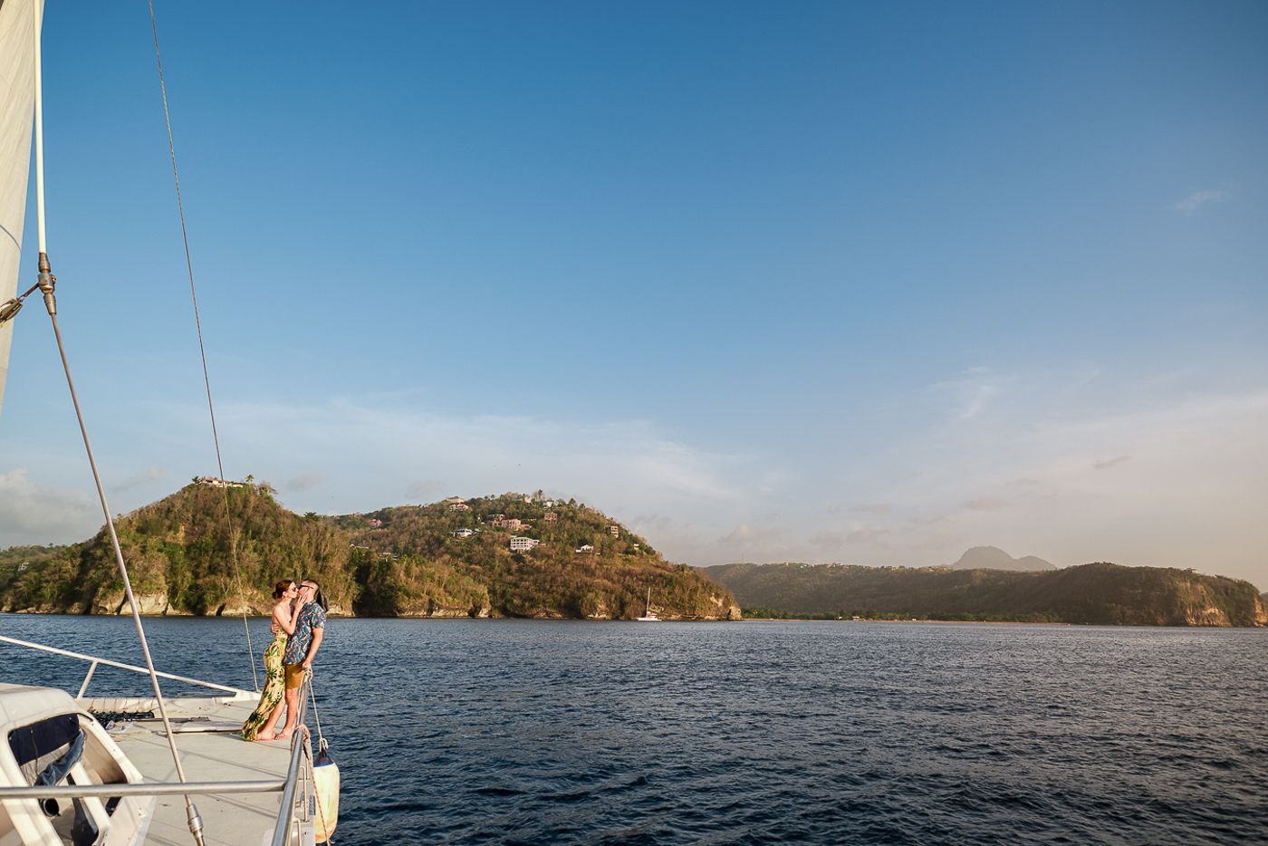 Caribbean wedding photographers Celeste & Reece documenting the couple’s champagne toast on a catamaran off the coast of Grenada, Caribbean