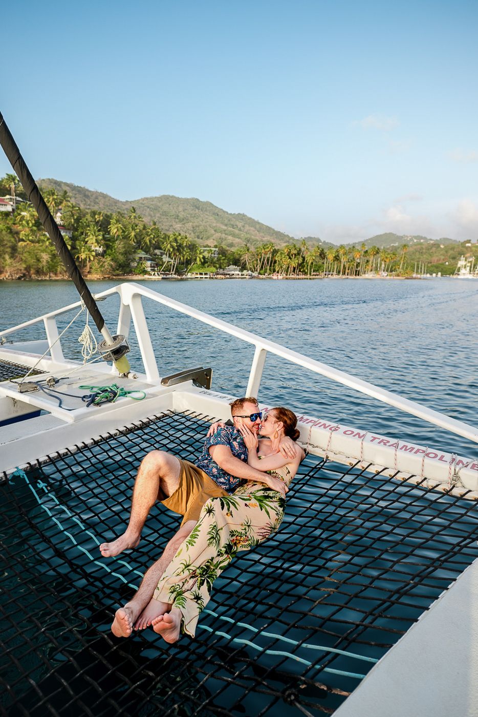 Caribbean wedding photographers Celeste & Reece capturing the couple on a catamaran for their post wedding sunset cruise at Sandals Resorts