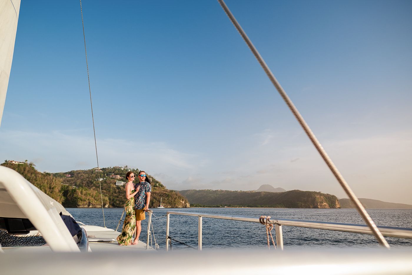 Caribbean wedding photographers Celeste & Reece documenting the couple’s champagne toast on a catamaran off the coast of Caribbean