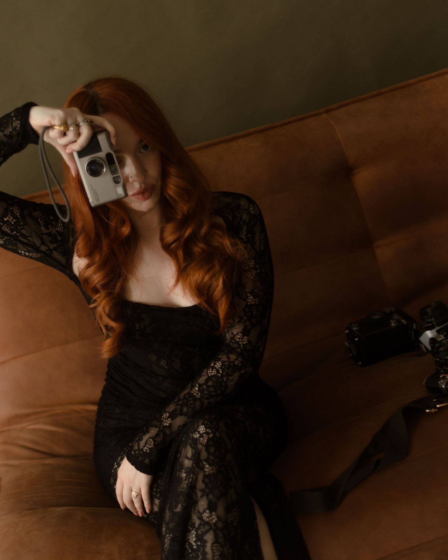 Artistic photo series featuring seated figure in elegant black lace dress against moody brown backdrop.