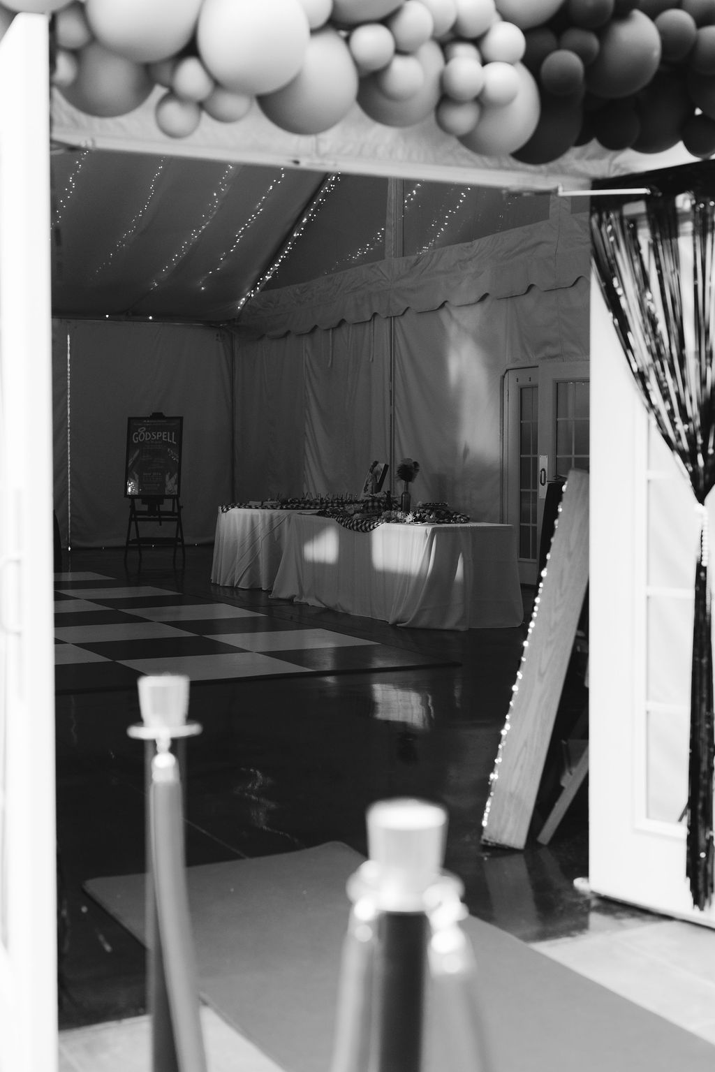 Black and white images of an indoor dance studio space with white drapes and dark flooring illuminated by natural light.