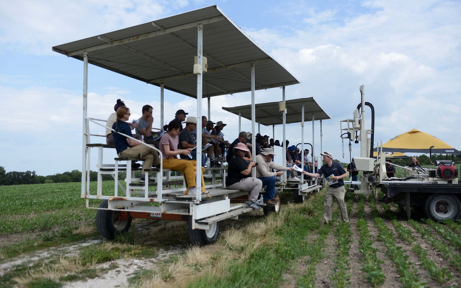 A group sits and watches a presentation at Mizzou Farm.