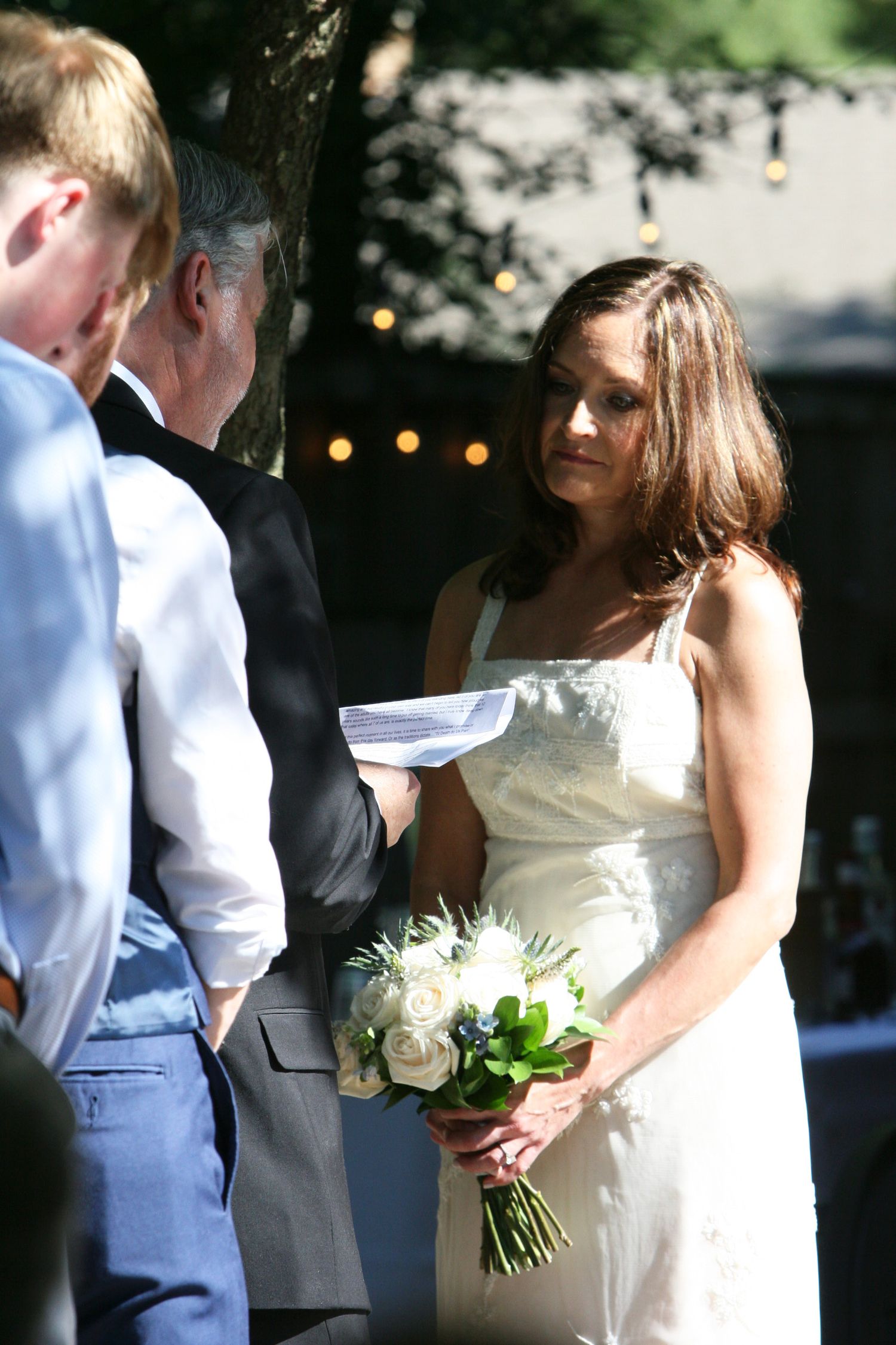 Jackie watches Rob as he recites his vows at their wedding.