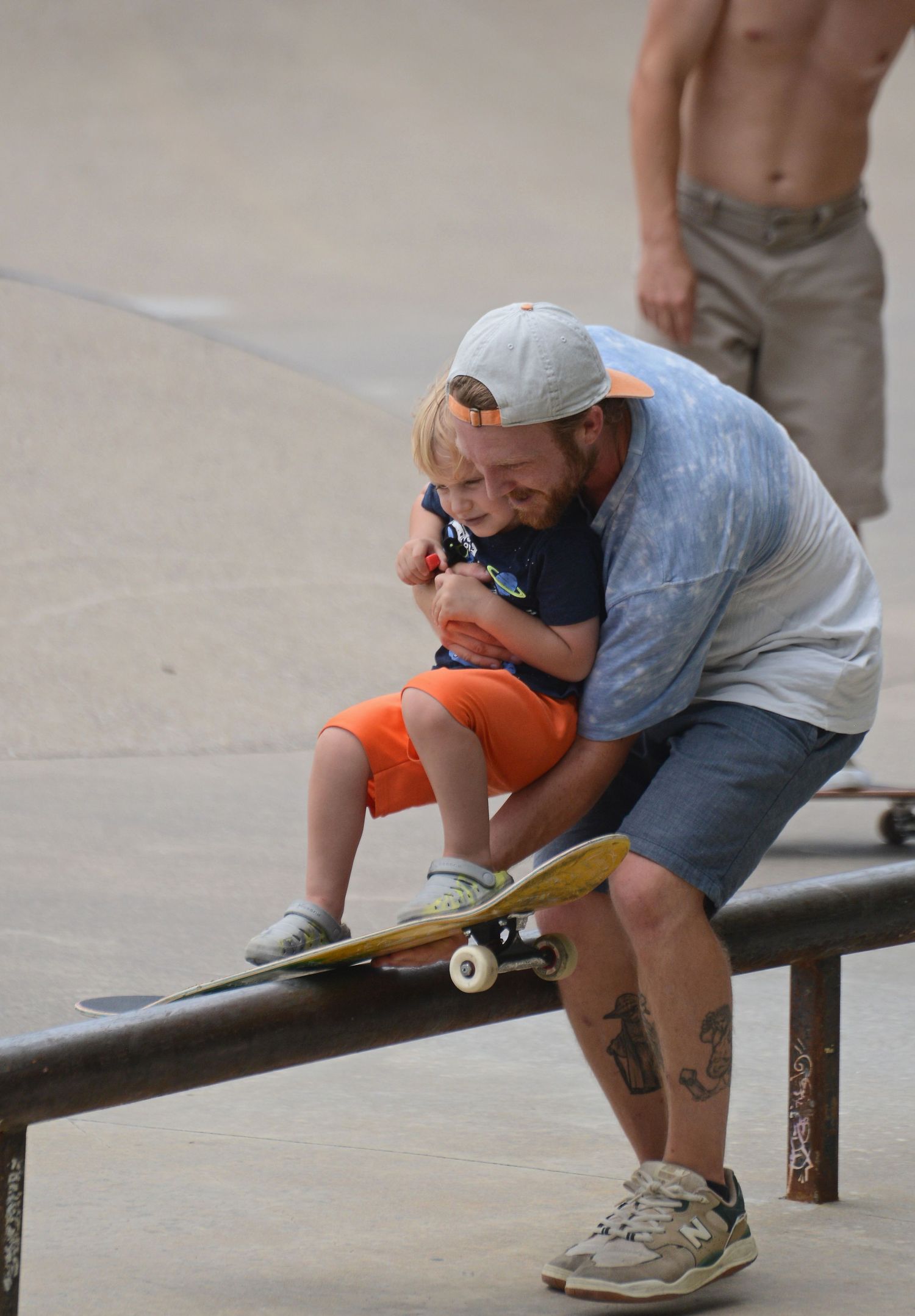 Kris Yates helps his son, Atlas Yates, 3, on the skateboard during a break in the competition Saturday at Columbia Skate Park.